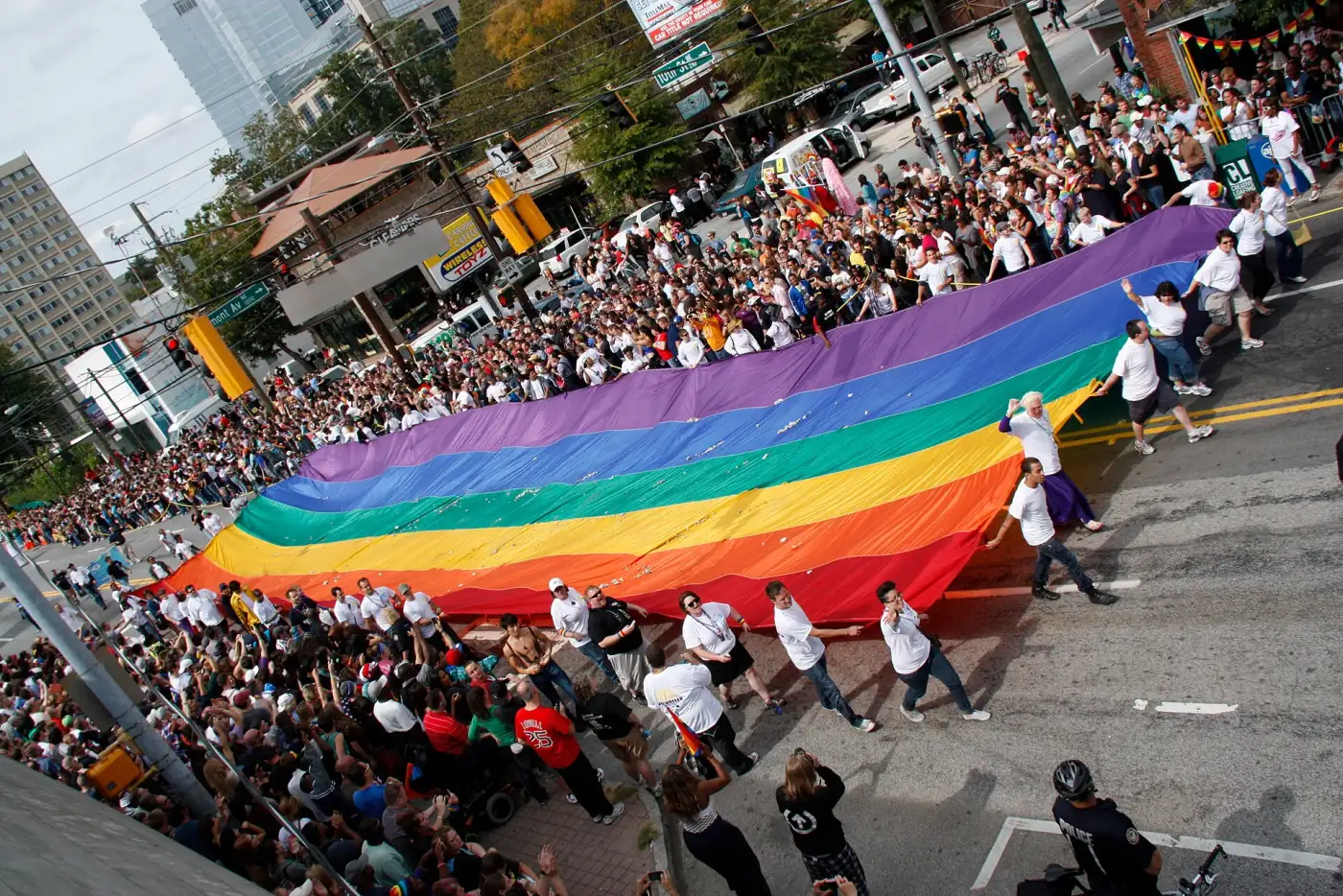 Marchers carry a giant rainbow flag along the Atlanta Pride Parade route in Midtown.