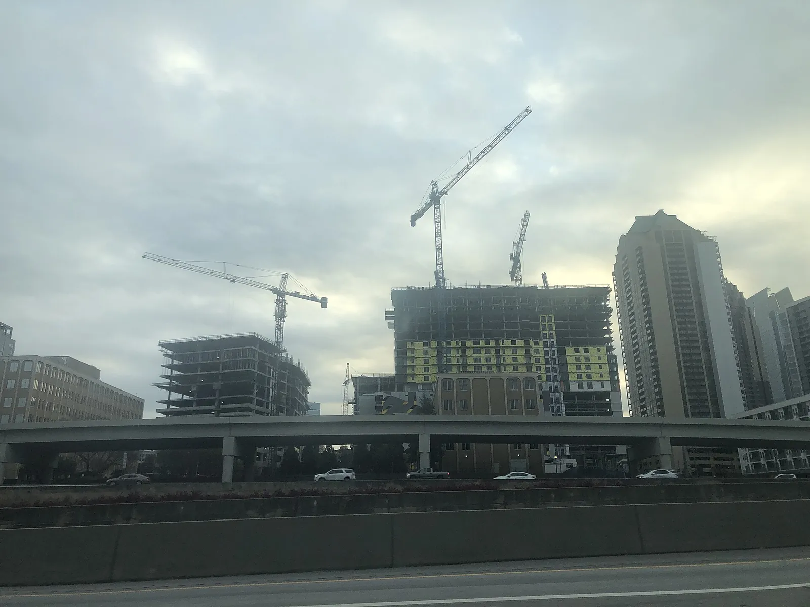 Tower cranes over high-rise construction seen from the Downtown Connector in Atlanta