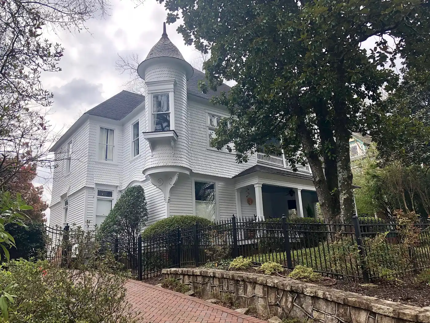 A Victorian house behind an iron fence in Inman Park, Atlanta
