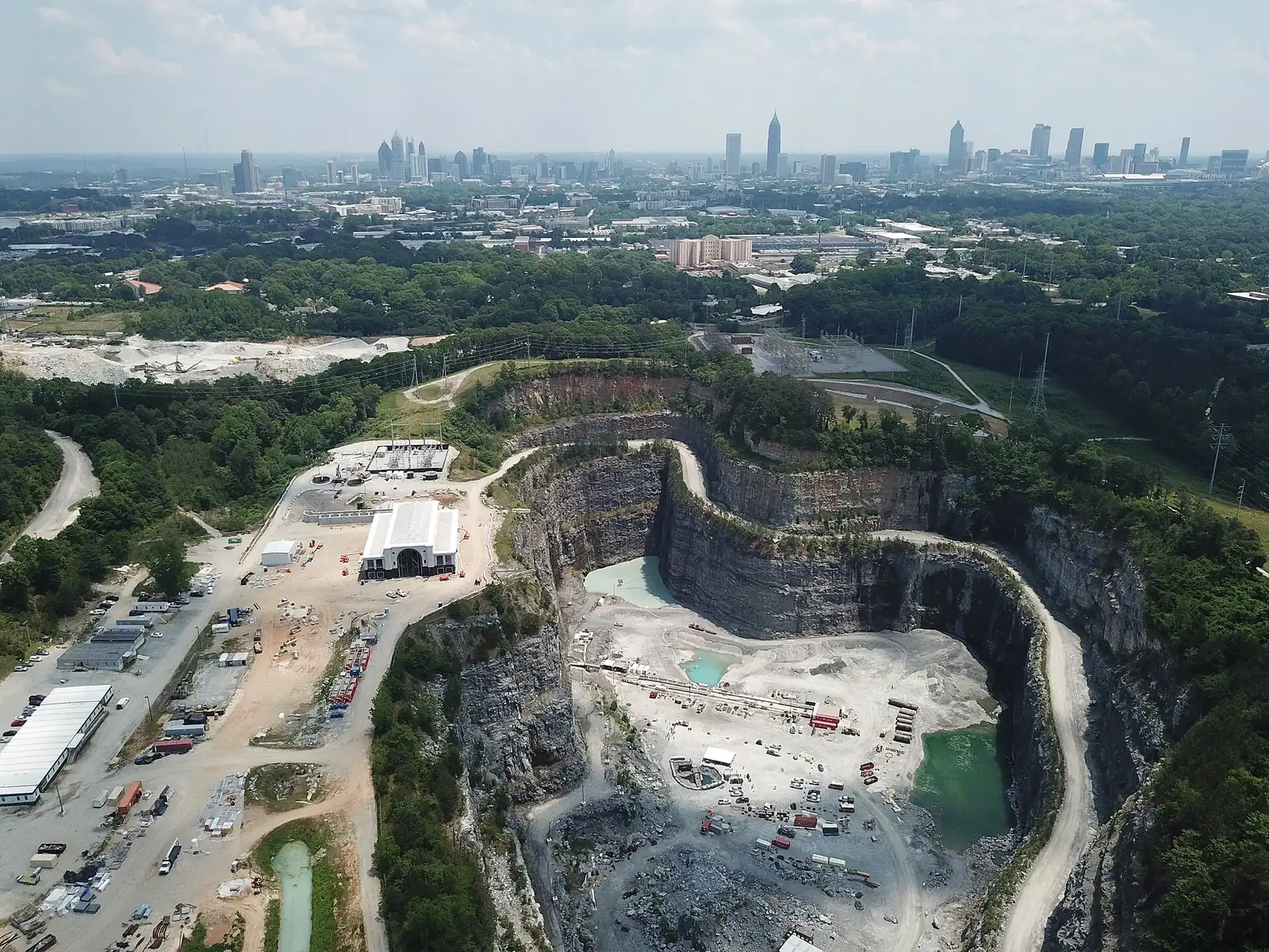 An aerial view of the Bellwood Quarry and Westside Park during construction, with the Atlanta skyline in the distance